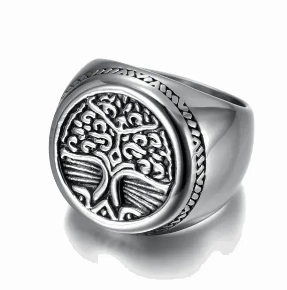 a silver ring with a tree of life on it