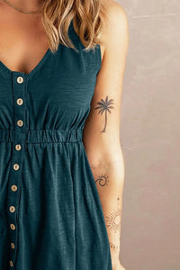 a woman wearing a green dress with a palm tree tattoo on her arm