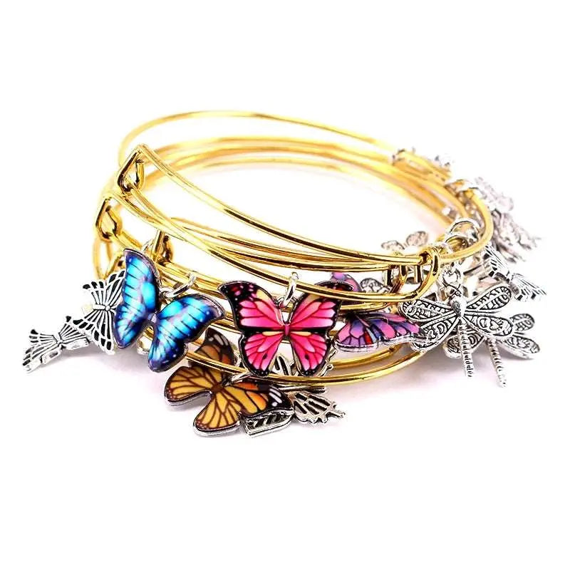 a stack of bracelets with butterflies on them