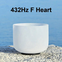 a white singing bowl sitting on a stone 432Hz F Heart
