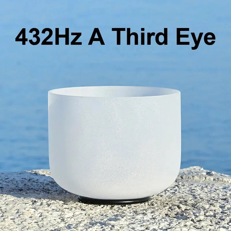 a white singing bowl sitting on a stone 432Hz A Third Eye 