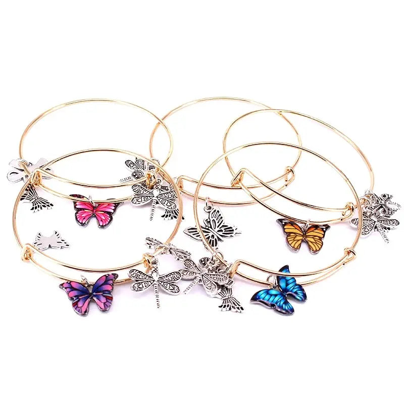 a set of four bracelets with butterflies on them