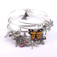 a close up of a bracelet with a butterfly on it