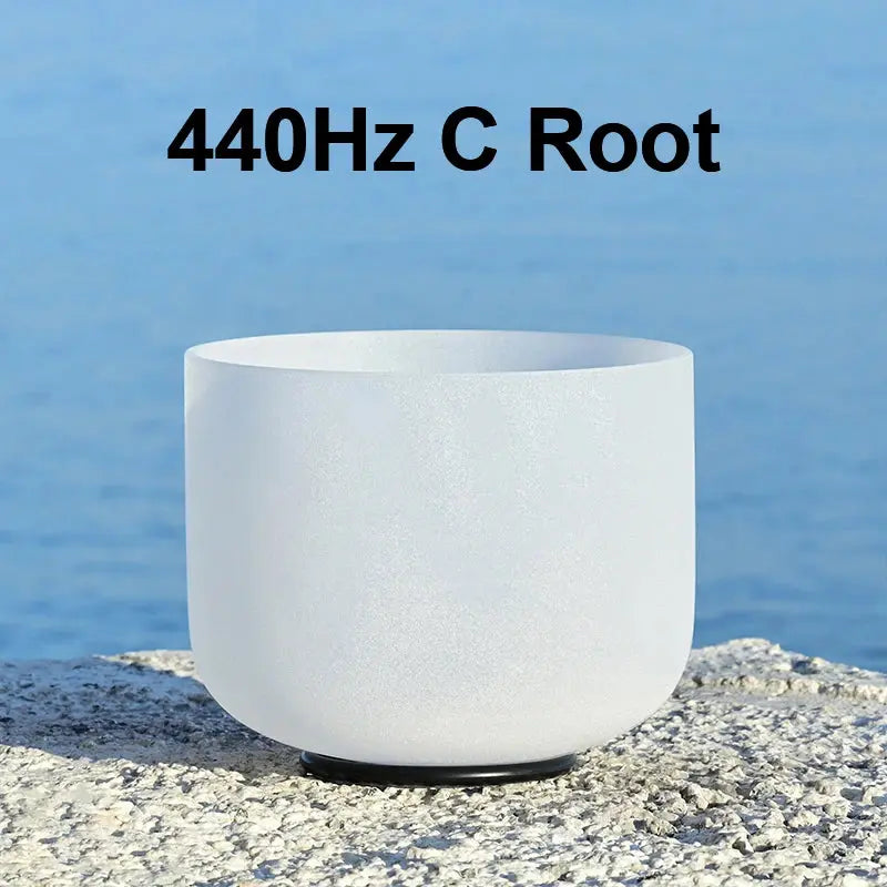 a white singing bowl sitting on a stone 440Hz C Root