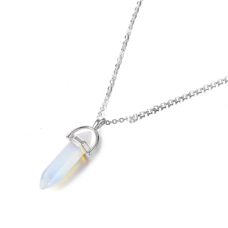 a white necklace with a crystal stone hanging from it