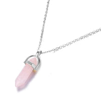 a necklace with a pink stone hanging from it