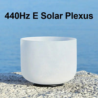 a white singing bowl sitting on a stone 440Hz E Solar Plexus