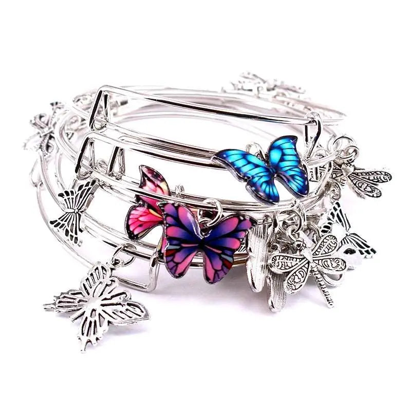a close up of a bracelet with butterflies on it