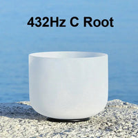 a white singing bowl sitting on a stone 432Hz C Root chakra