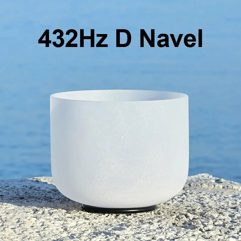 a white singing bowl sitting on a stone 432Hz D Navel