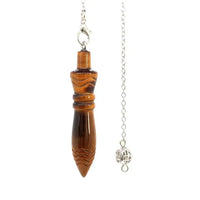 a necklace with a wooden object hanging from it's side