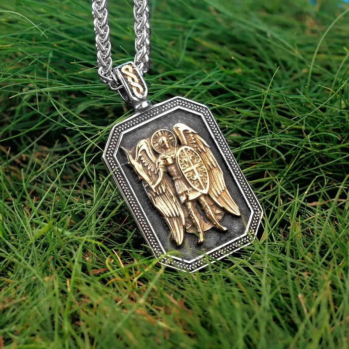 a necklace with a picture of two angels on it