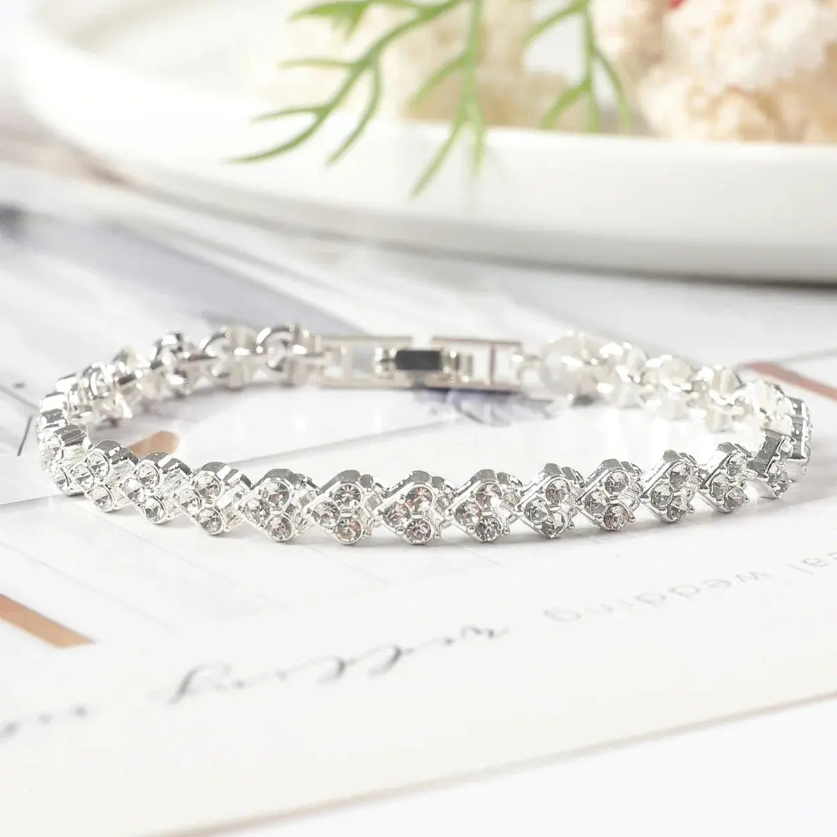 silver bracelet with rhinestones placed in heart shape
