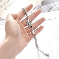 silver bracelet with a seahorse charm on it