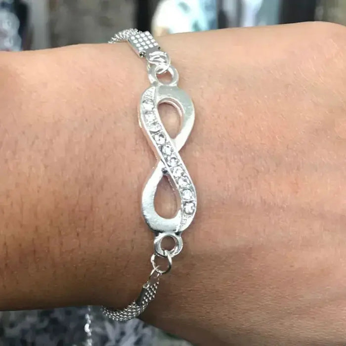a woman's arm with a silver bracelet on it
