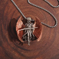 a necklace with an angel holding a sword