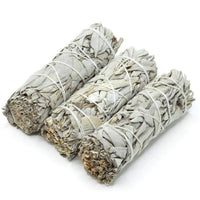 three white sage smudges wrapped in twine