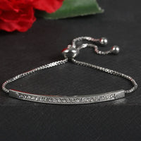 silver bracelet with rhinestones on a gray background