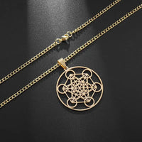 a gold necklace with an intricate design on it