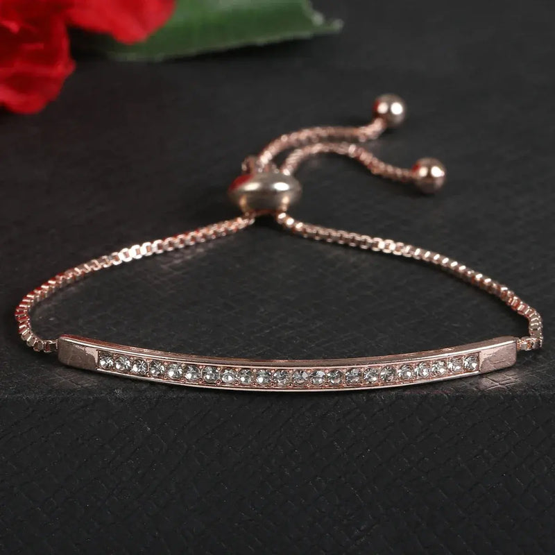 rose gold bracelet with rhinestones on a gray background
