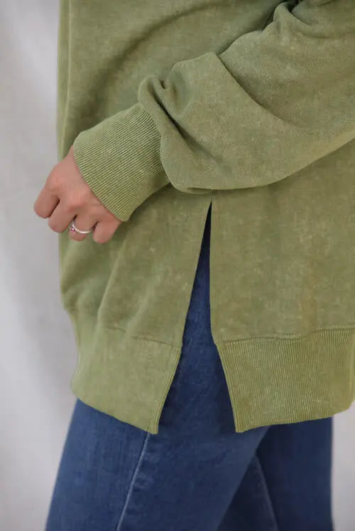 a close up of a person wearing a green sweater